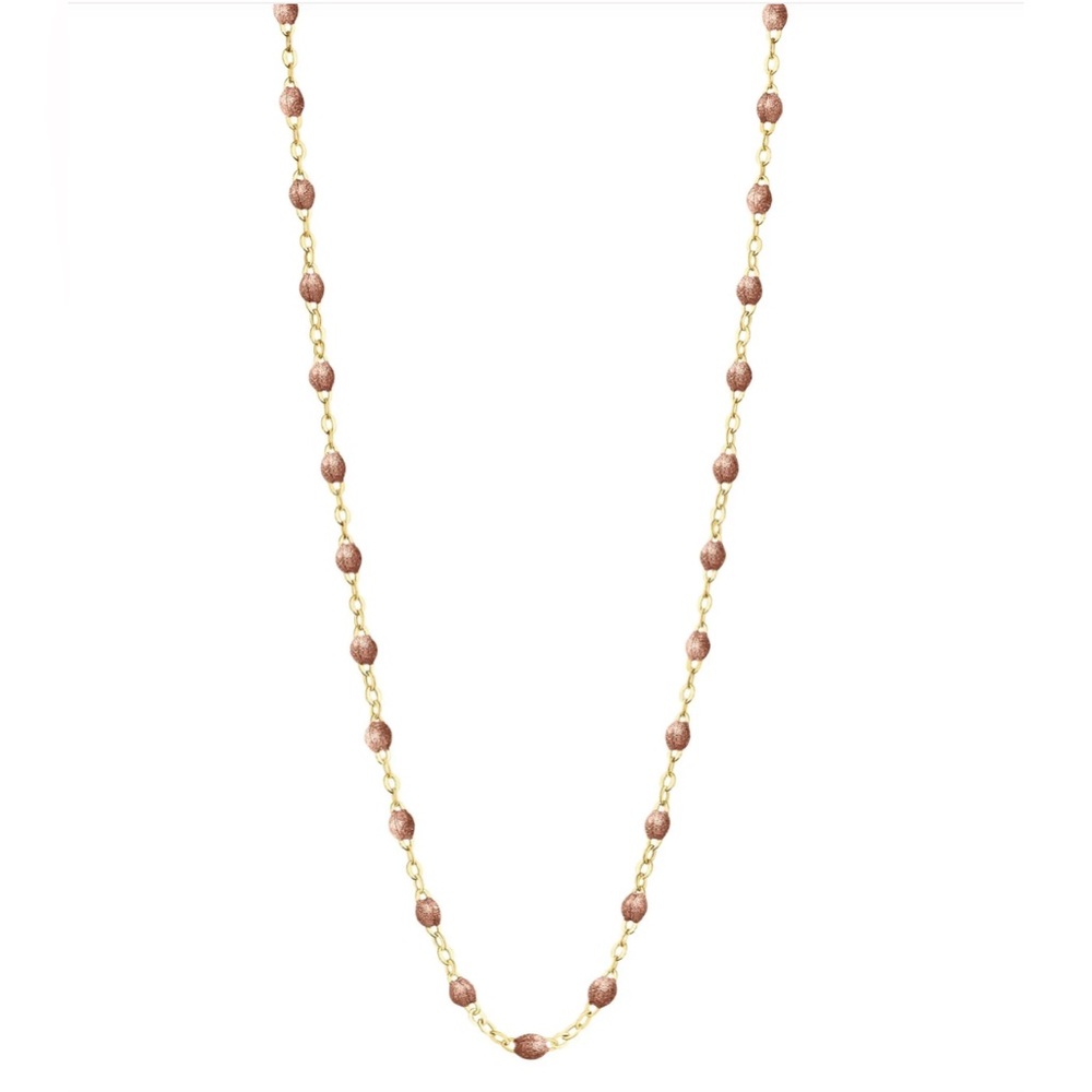 The Classic Gigi necklace features 18 carat gold, and sparkly copper